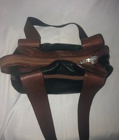 "Joanel Natural Nappa 100% Leather Shoulder Bag/Purse  Black and Brown Colours  New Condition  Made in Canada  Measure about 14\"x9.5\"Show less" Purse Black, Brown Color, Leather Shoulder Bag, Black And Brown, Shoulder Bags, Hand Carved, Genuine Leather, Purse, Shoulder Bag