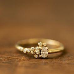 a diamond ring sitting on top of a wooden table