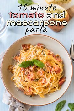 a white bowl filled with pasta and topped with basil