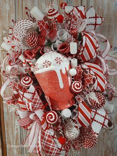 a red and white christmas wreath with candy canes, candies and lollipops