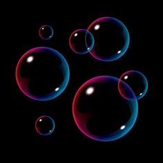 soap bubbles floating in the air on a black background