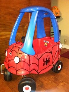 a little red car with spiderman on it's side and the words google search below