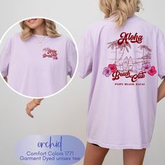 Custom front and back design aloha beach club tees! We love the pop of colors used in the design--perfect for summer and it's giving fun retro surfer style vibes! Perfect for a beach day, Hawaiian vacation, tropical vacation, beach lover, this shirt will appeal to many. We can also put this design on a sweatshirt, hoodie, long sleeve tee (comfort colors brands when, etc! Just message us!    Comfort colors employs 2 different dye processes  to create 2 different types of color consistencies.  The Hawaiian Graphic Print Camp Shirt For Beach Season, Summer Hawaiian Shirt With Graphic Print For Surfing, Graphic Print Hawaiian Shirt For Beach Season, Hawaiian T-shirt With Screen Print, Hawaiian Shirt With Graphic Print For Beach Season, Retro Short Sleeve T-shirt For The Beach, Purple Short Sleeve T-shirt For Beach, Graphic Print Hawaiian Shirt For Beach, Graphic Print Hawaiian Shirt For Surfing