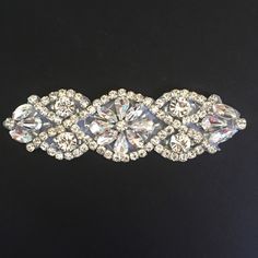 "Highest quality crystal rhinestone applique for use in creating a custom baby headband, hair piece, bridal garter, or accent to any garment. Applique is made with clear crystal rhinestones in a silver setting. Resin backing for hotfix/iron on/sew on. 4\" long by 1\" wide Crystal Trimmings & Appliques is a wholesale distributor of high-end bridal trim. Larger quantities are available by request, or custom orders are welcome. Please note that as these are trim/applique only, and not attached White Crystal Bridal Belt With Rhinestones, Silver Wedding Crystals, Elegant Silver Crystals For Wedding, Elegant Silver Wedding Crystals, Bedazzled White Crystal Jewelry, Silver Crystal Bridal Belt With Bling, Crystal Bridal Belt With Rhinestones, Diy Baby Headband, Bridal Trim