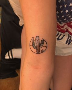 a woman with a small cactus tattoo on her arm