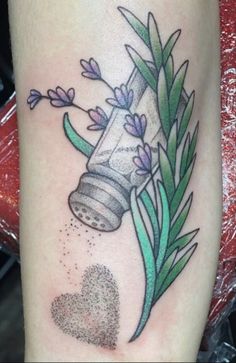 a tattoo with flowers and a bottle on it