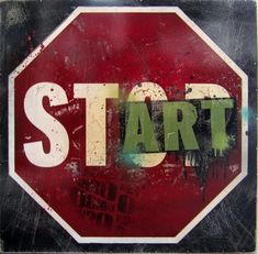 a stop sign with the word start painted on it