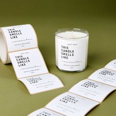 candles and labels on a table with a candle in the middle next to each other