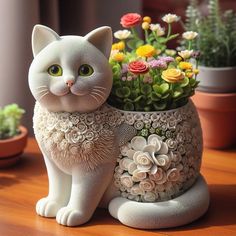 a white cat statue sitting on top of a wooden table next to potted plants