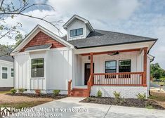 a small white house with red trim on the front porch