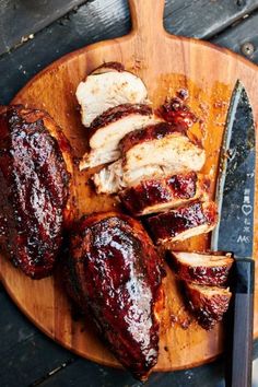 sliced pork with bbq sauce on a cutting board