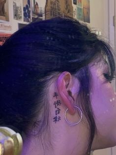 a woman with a tattoo on her left ear