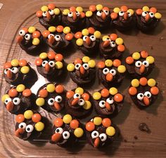 some cupcakes with googly eyes are arranged in the shape of turkeys