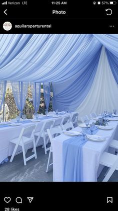 a table set up with blue and white linens for a party or wedding reception