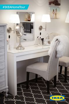 a white desk with two chairs and a mirror