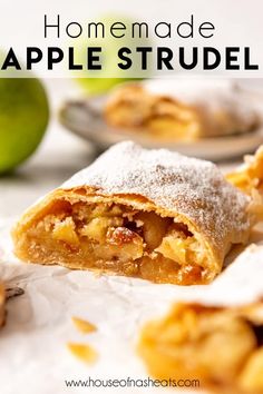 an apple pie is cut in half and sitting next to some other fruit on the table