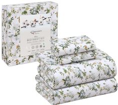 the bedding set is white with flowers on it and has four sheets in front