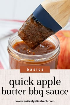 an apple butter bbq sauce in a glass jar with a wooden spoon sticking out of it