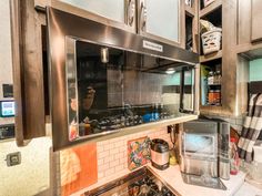 a kitchen with stainless steel appliances and cabinets