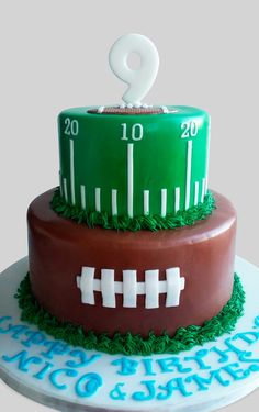 a football themed cake with the number two on it's top and bottom tier