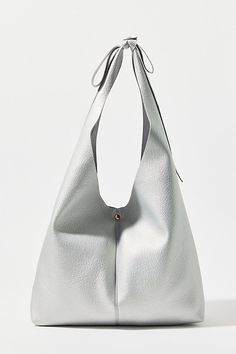 New favorite everyday bag tied up with a bow with this slouchy hobo bag in faux leather from Kimchi Blue. This large purse is finished with a bow shoulder strap. Only at UO. Features Kimchi Blue bow faux leather hobo bag Slouchy everyday bag in soft faux leather Large everyday carry bag style Hobo bag silhouette Bow shoulder strap Pin closure UO exclusive Content + Care PU Spot clean Imported | Kimchi Blue Bow Faux Leather Hobo Bag in Silver, Women's at Urban Outfitters Chic Hobo Tote Bag With Silver-tone Hardware, Chic Hobo Bag With Silver-tone Hardware, Chic Hobo Bag With Silver-tone Hardware For Shopping, Versatile Hobo Bag With Magnetic Closure For Shopping, Chic Hobo Bucket Bag With Adjustable Strap, Chic Hobo Shoulder Bag With Magnetic Closure, Tote Hobo Bag With Silver-tone Hardware For Errands, Chic Bucket Bag With Removable Pouch, Chic Hobo Bucket Bag With Removable Pouch