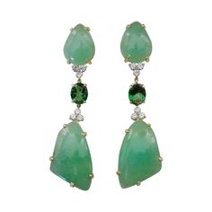 Free-form cabochons of green beryl (origin: Brazil) are perfectly book matched in these dramatic dangle earrings. Beryl is a large family of gems. Well known members include emerald and aquamarine. Lesser known but equally beautiful members are Morganite (pink) and heliodor (also known as golden beryl). These gems are a luscious "lime sherbet" color and possess a glass-like polish. Complimenting the beryls are a pair of forrest green topaz along with white diamonds. All are set in hand fabricate Formal Green Earrings With Gemstone Accents, Green Earrings With Gemstone Accents For Formal Events, Elegant Green Cabochon Earrings, Green Long Drop Earrings For Formal Occasions, Fine Jewelry Green Cabochon Earrings, Lime Sherbet, Golden Beryl, South Sea Pearls Earrings, Bridal Jewels