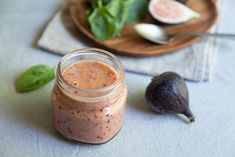 an avocado and some other food items on a table with a spoon next to it