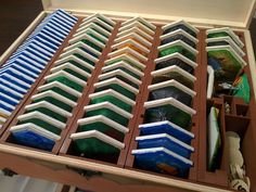 an open wooden box filled with lots of different colored items