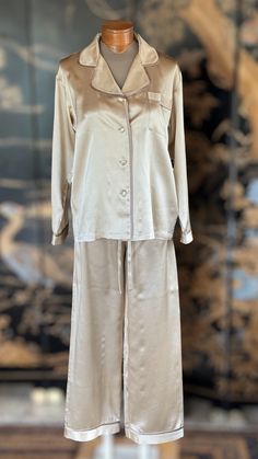 These high-end charmeuse silk pajamas are 100% natural, allergen-free and hypoallergenic. Kumi Kookoon is world-renowned for its fine, high quality silk products. Handmade 100% charmeuse silk Color: Ivory Measurements: SmallChest width: 20.5"Sleeves: 21.5"Elastic waistHips: 21.5"Pants length: 40.4" MediumChest width: 22"Sleeves: 23"Elastic waistHips: 23"Pants length: 42" LargeChest width: 23"Sleeves: 23.5Elastic waistHips: 24"Pants length 43" Elegant Long Sleeve Sleepwear Set, Elegant Cream Silk Sets, Chic Silk Loungewear Sets, Elegant Silk Sleepwear Sets, Elegant Silk Sleep Sets, Chic Silk Sleepwear With Satin Finish, Silk Long Sleeve Sleepwear For Wedding Night, Elegant Satin Sleepwear For Pajama Party, Silk Long Sleeve Bedtime Set