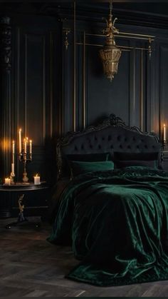 a bedroom with dark green velvet bedding and candles