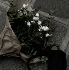 a bouquet of white roses on the ground