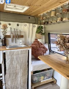 the interior of a small camper with lots of storage space and decorations on the walls