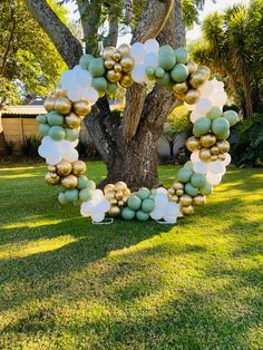 a wreath made out of balloons in the grass