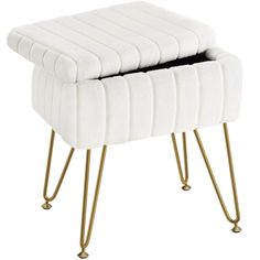 a white stool with gold legs and a black top