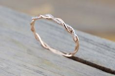 a close up view of a wedding ring on a wooden surface