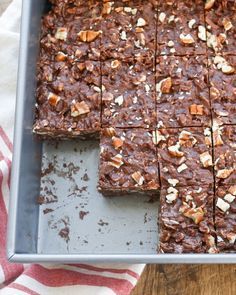 a pan filled with brownies on top of a wooden table