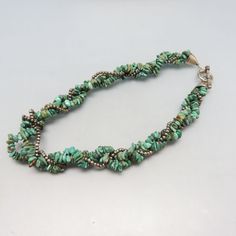 This lovely vintage necklace is made up of two strands of polished real turquoise chips and one strand tiny sterling beads braided together, It has a sterling toggle clasp and measures 3/4 inches wide by 18 inches long. It is a more tailored look than most. The three strand necklace in MINT condition. This will arrive in a lovely gift box. If you like vintage costume jewelry, old silver, bolo ties and Native American jewelry, kindly check out my Etsy store at www.etsy.com/shop/PANDPF Three Strand Necklace, Bolo Ties, Real Turquoise, Jasper Pendant, Vintage Turquoise, American Jewelry, Toggle Clasp, Native American Jewelry, Vintage Costume Jewelry