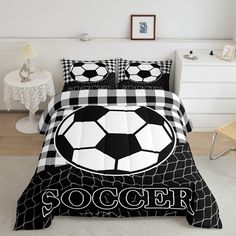 a black and white comforter with a soccer ball on it