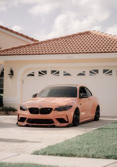 an orange car parked in front of a house