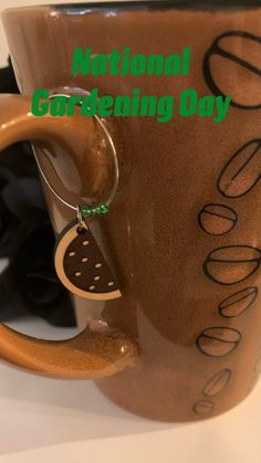 a close up of a coffee cup with the words national gardening day written on it