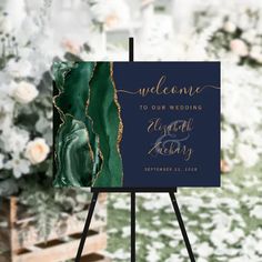 an easel with a sign that says welcome to our wedding