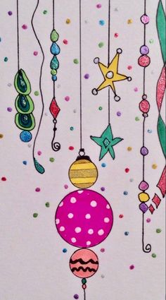 a card with some ornaments hanging from it's strings and confetti on them