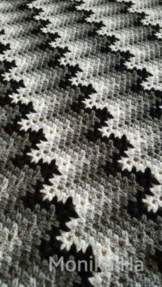 a large black and white rug with stars on the bottom is shown in close up