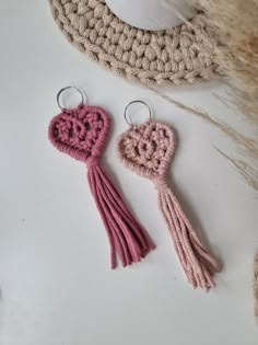 two crocheted key chains with hearts on them