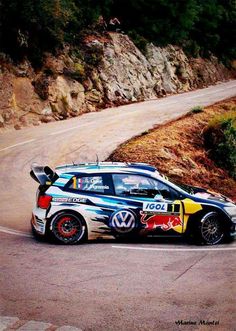 a rally car driving down a winding road