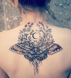 the back of a woman's shoulder with an owl and butterfly tattoo on it