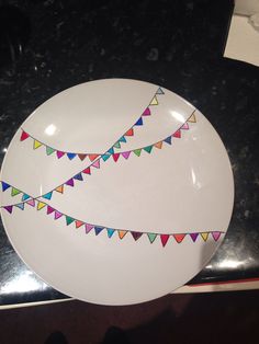 a white plate with multicolored bunting on it