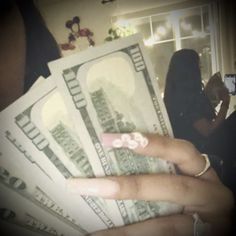 a person holding money in their hand