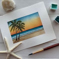 an image of a beach scene with palm trees and seashells on the table