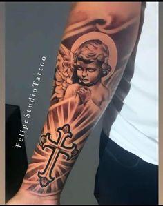 a man with a cross and angel tattoo on his arm